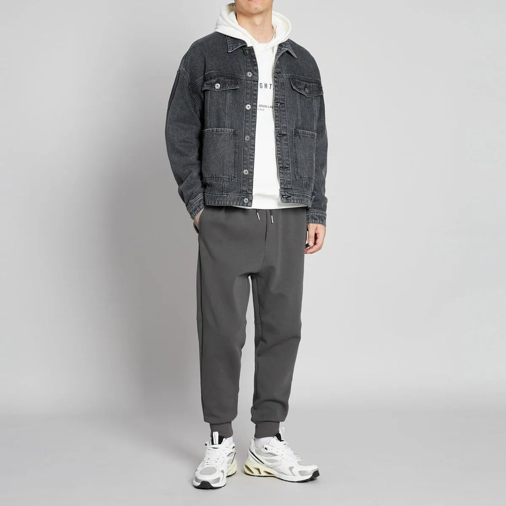 Men's mid-waist drawstring casual pants in black cotton blend, loose nine-length fit.