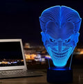 A 3D acrylic LED lamp emitting a gradient of colours, shown with its square base and remote control.