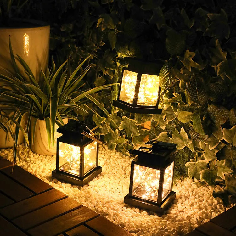 Black solar wind lamp with warm white LED light on outdoor table