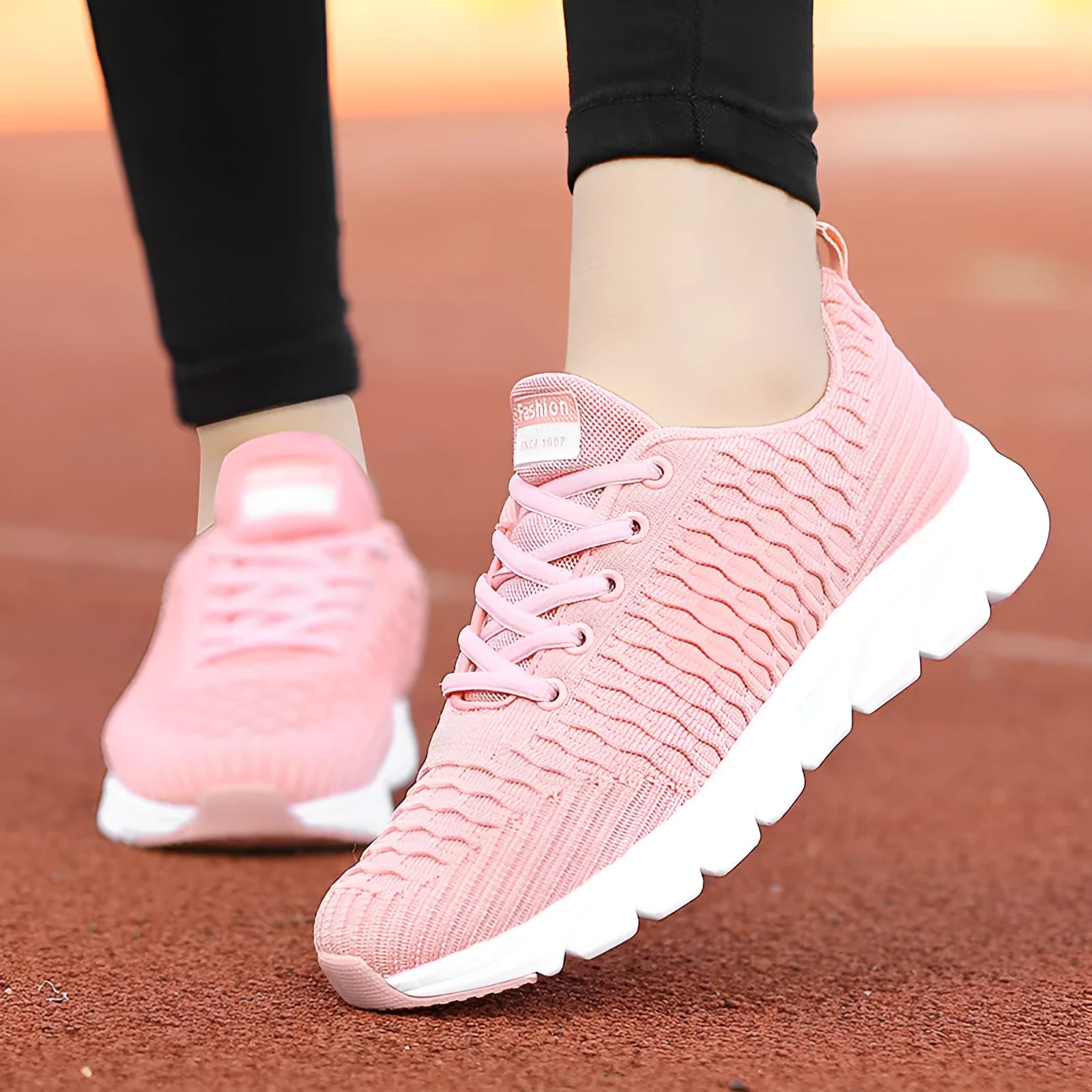 Women's running shoes with fly weave upper in black, pink or white on wear-resistant outsole.