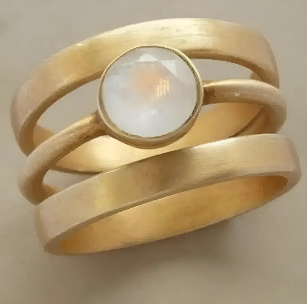 Gold-coloured geometric titanium steel ring with a micro-inlaid white chalcedony pattern.