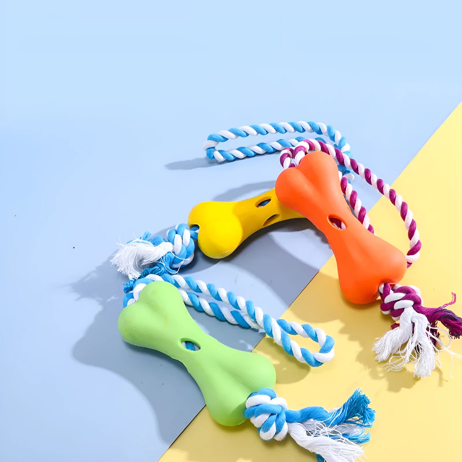 Green porous rope bone dog chew toy with knotted texture for treat stuffing and teeth relief