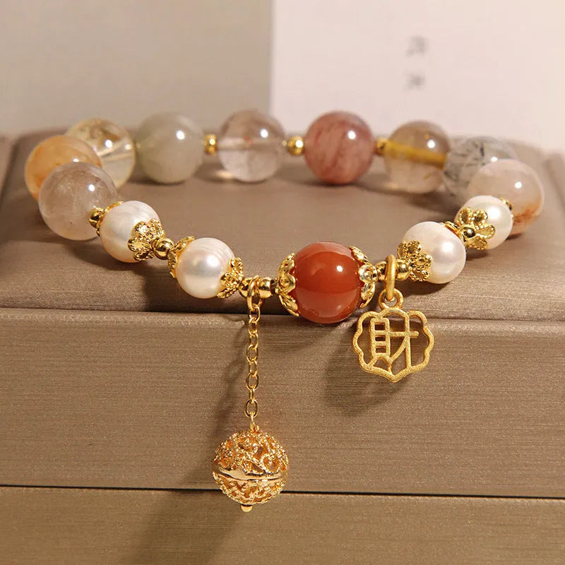 Women's crystal bracelet with colourful hair crystal beads, four pearls, and a Chinese Cai charm.