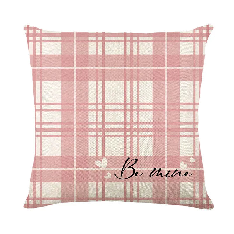 Square pillow cover with a printed red and black plaid heart design on a white background.