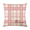 Square pillow cover with a printed red and black plaid heart design on a white background.