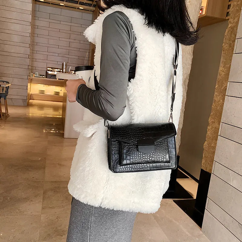 Vintage PU leather crossbody bag in black showing interior organisation for phones and wallets