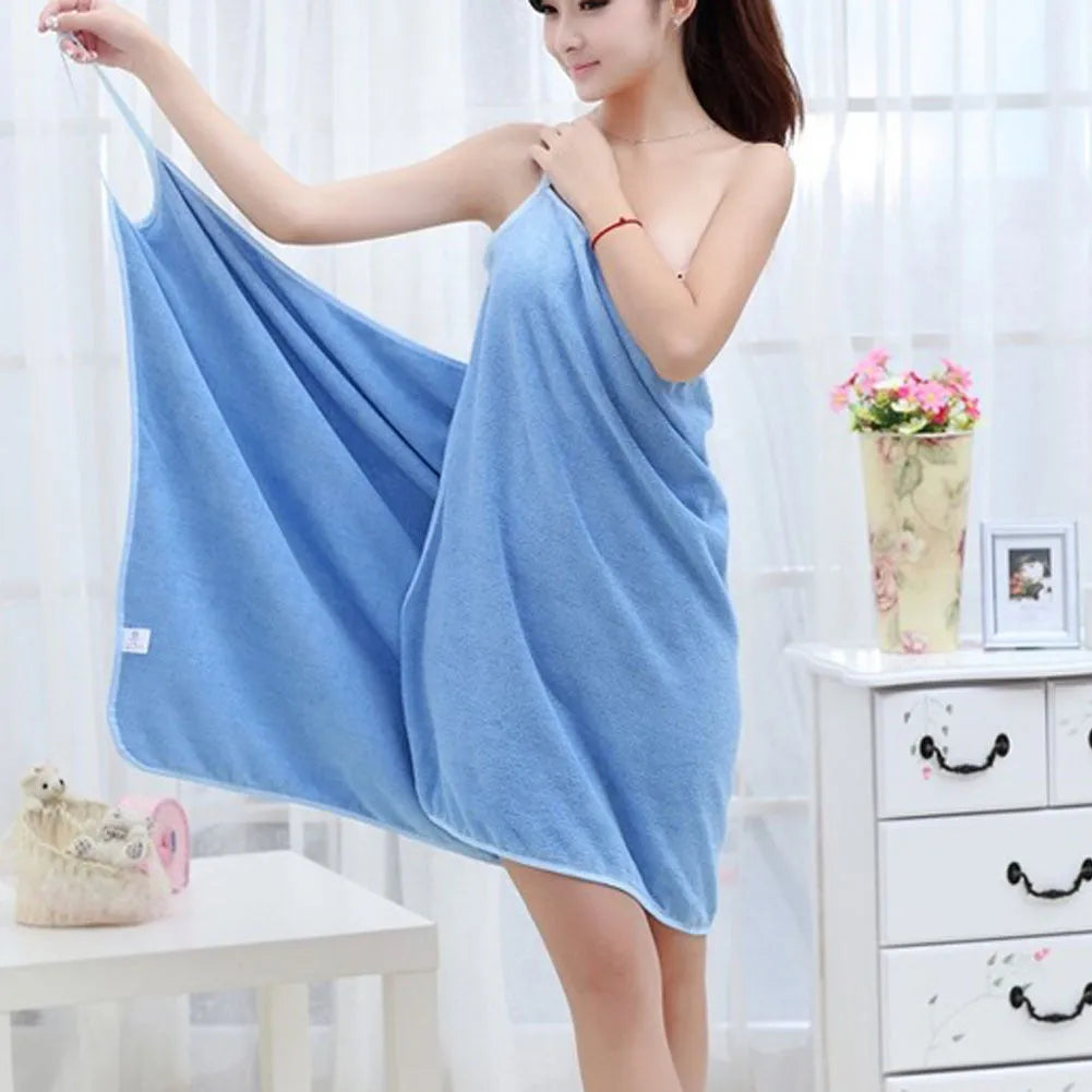 Pink beach dress towel worn as a cover-up, showing its long rectangular shape and soft texture.