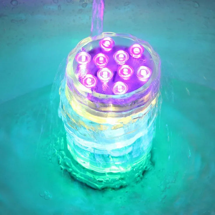 IP68 waterproof LED remote control diving light with 16 colour modes placed in a glass vase of water