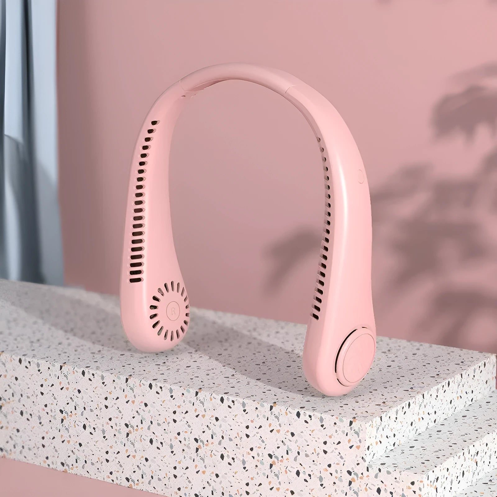 Pink USB rechargeable bladeless neck fan with flexible neckband on a white background.