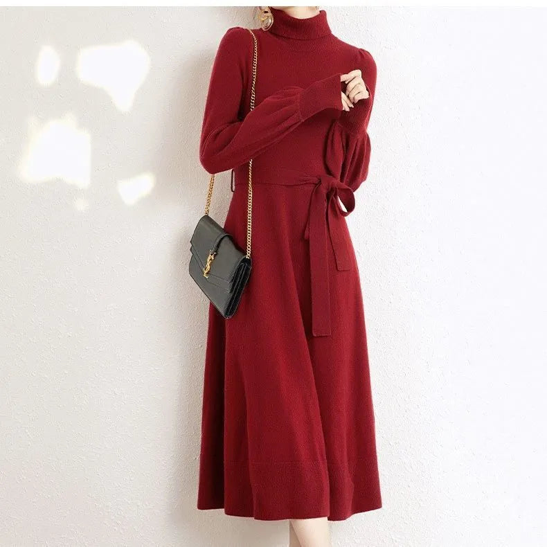 Women's rose red turtleneck knitted dress with long sleeves and a mid-length skirt.