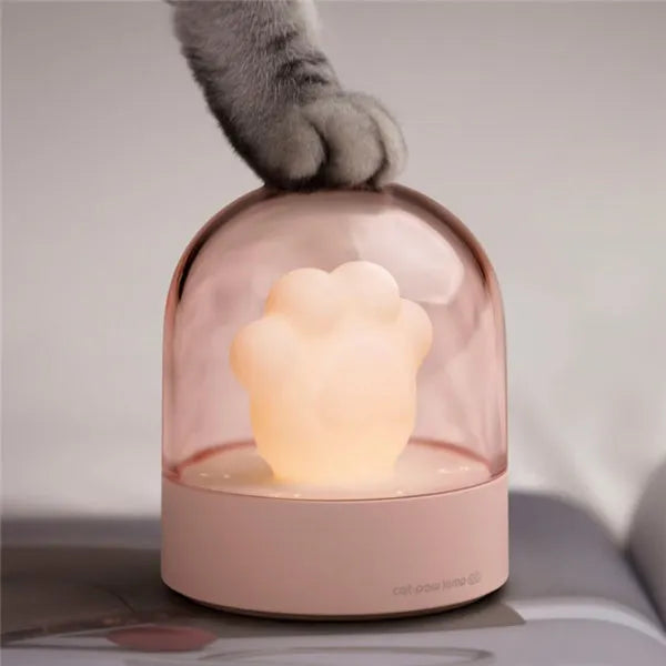 Grey or pink cat paw shaped USB rechargeable night light with rotating soft light and music box feature