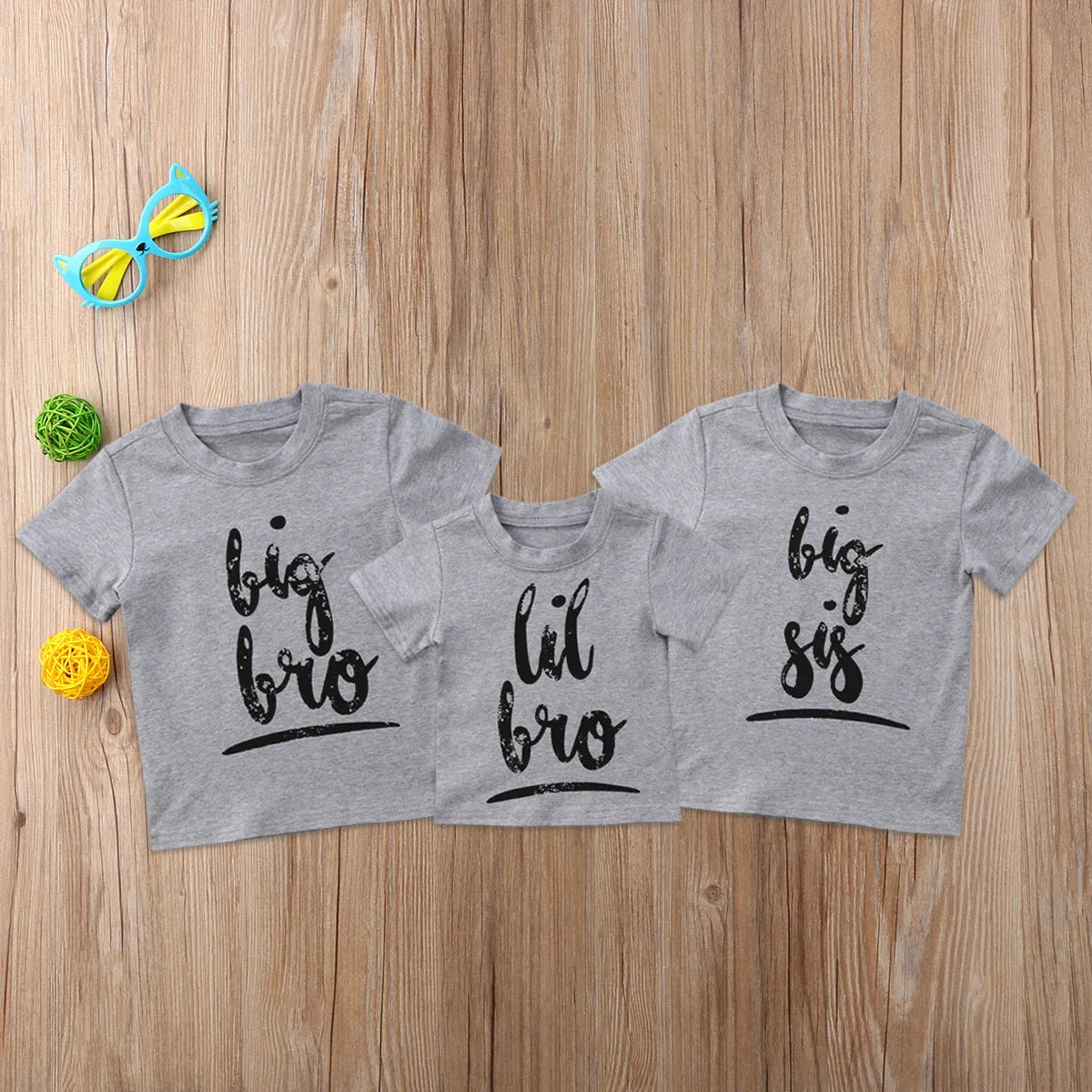 Grey kids cotton t-shirt with printed brother sister designs showing size range from 60cm to 140cm