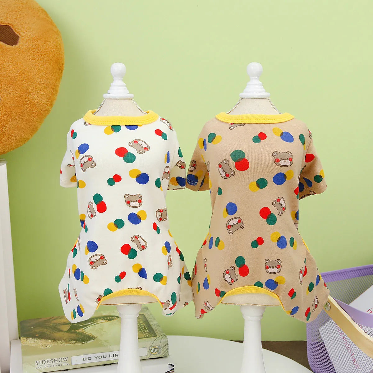 Beige dog t-shirt with a colourful cartoon ball bear design, showing a casual fit on a pet.