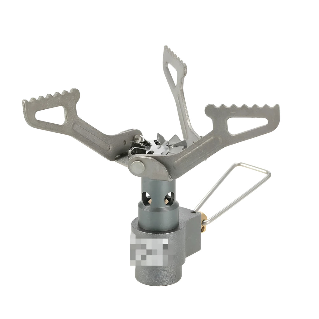 Portable metal propane camping stove with one-piece furnace design on a outdoor surface.
