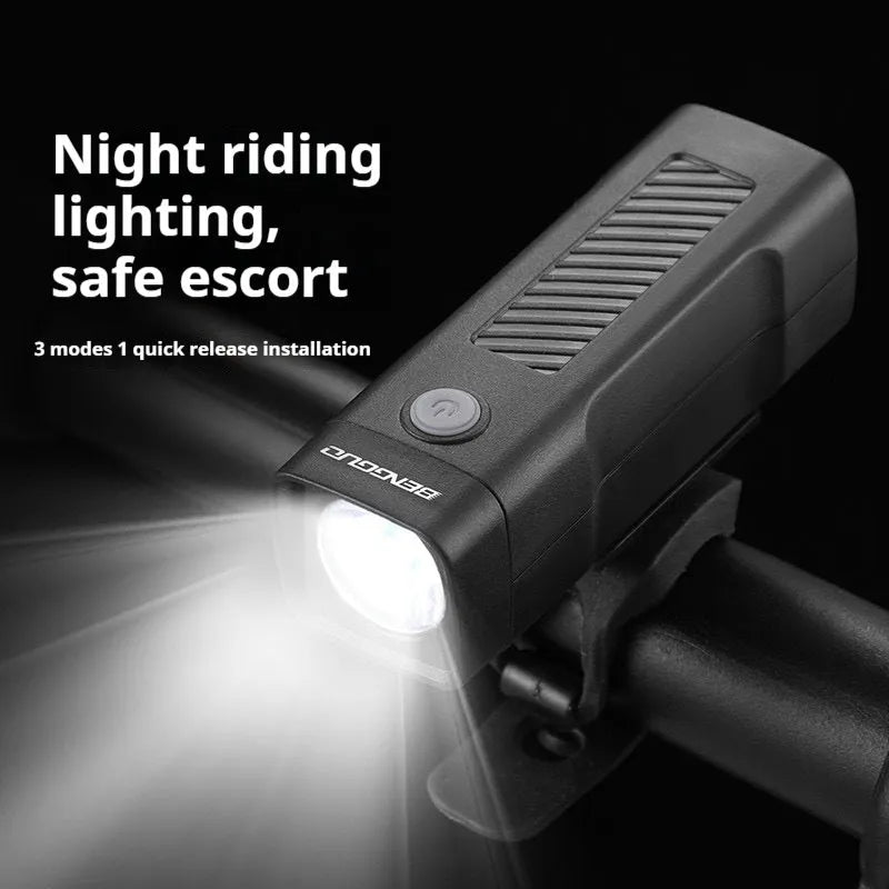 Black USB rechargeable bicycle headlight with quick release strap bracket on handlebars