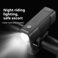 Black USB rechargeable bicycle headlight with quick release strap bracket on handlebars