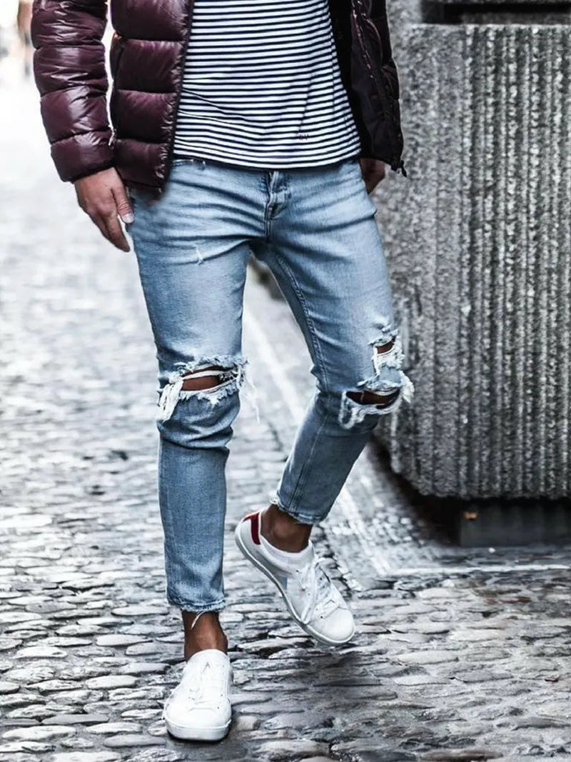 Men's light blue straight fit distressed jeans with embroidered details and zip fly