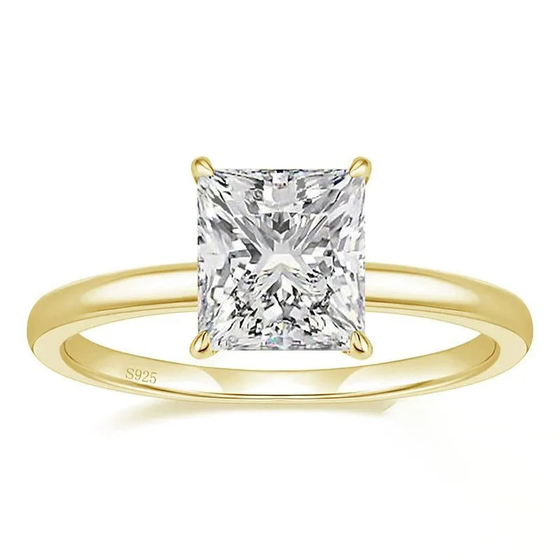 Women's geometric sterling silver ring in gold, rose gold, or silver on a grey background.