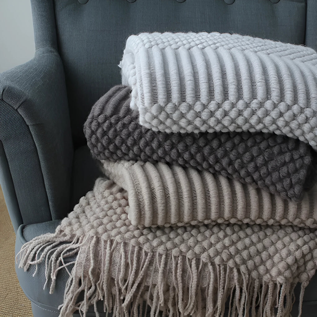 Small lightweight polyester nap blanket in dark grey, khaki, or light grey, shown folded, dimensions 127cm by 170cm.