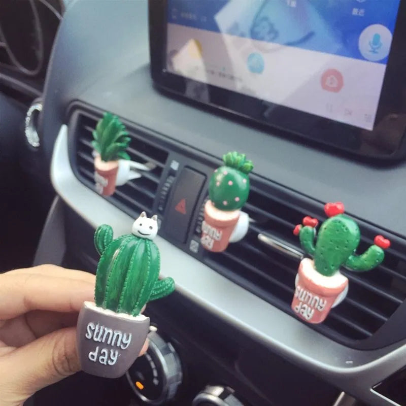 Cute green cactus car air freshener vent clip attached to car air conditioning vent