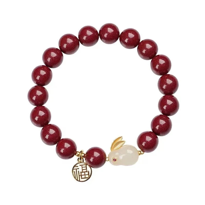 Purple gold sand cinnabar bracelet with a jade hare charm, shown with 6mm and 8mm bead size options.