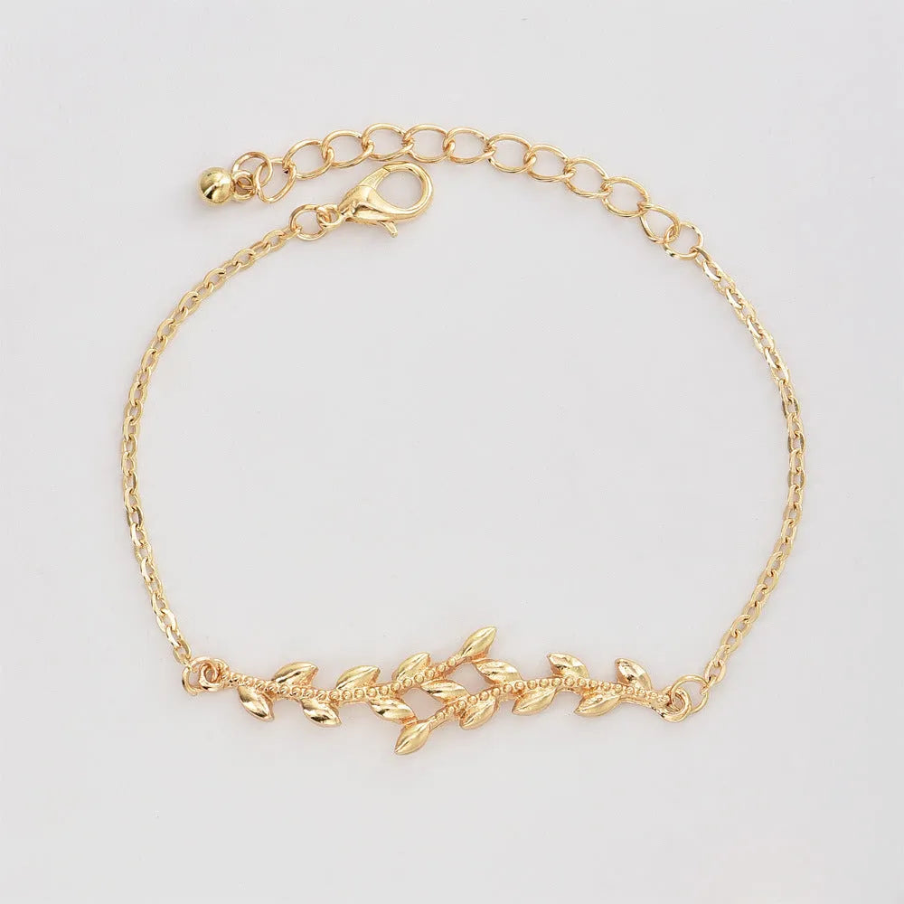 Gold alloy geometric bangle combination set with electroplated finish and about 16cm diameter