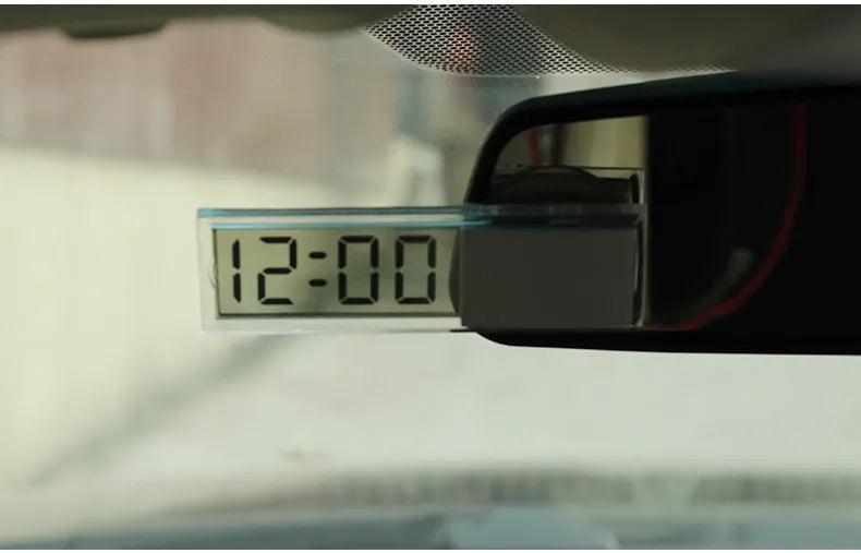 Dot matrix LCD car clock with suction cup mount placed on dashboard