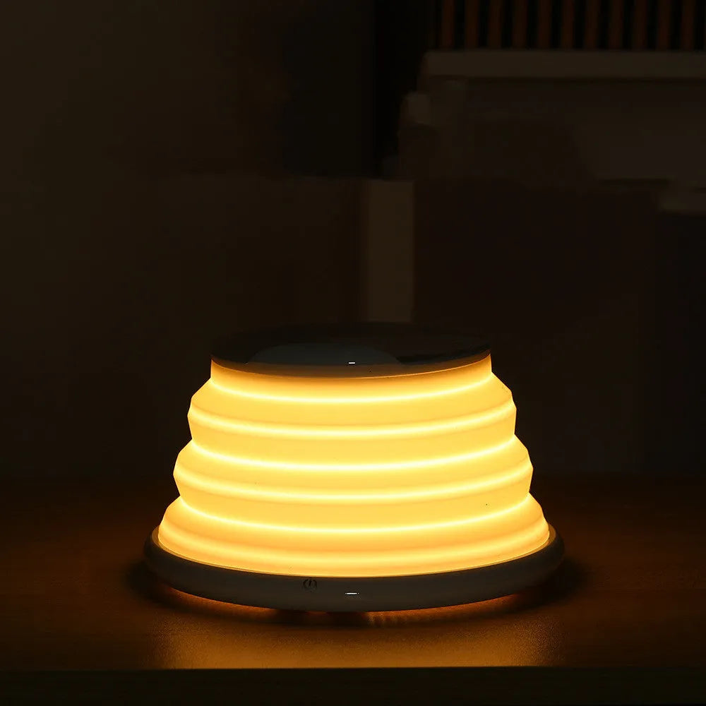 Grey wireless charging pad on a desk, 138x138x30mm, with silicone top surface and LED indicator