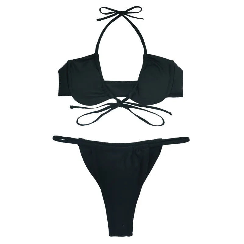 Black and mint green women's nylon bikini swimsuit set on a hanger.