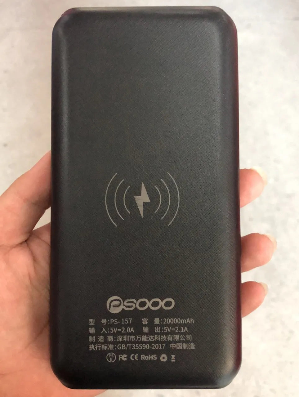 Black wireless charging power bank with three USB ports for iPhone Samsung and Xiaomi phones