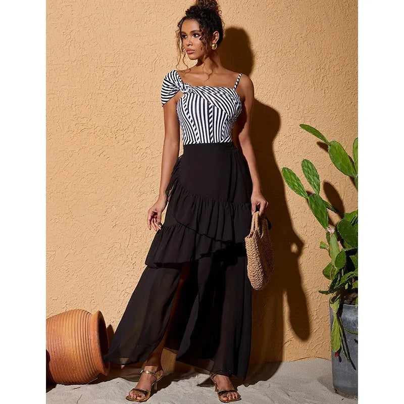 Women's striped one-piece swimsuit with black ruffled skirt detail for swimming and beachwear
