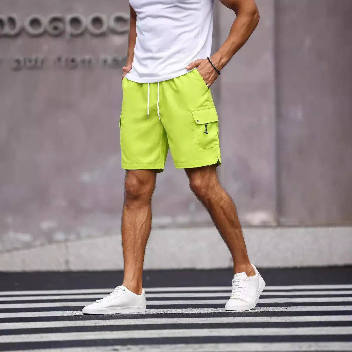 Men's loose fit workwear shorts in fluorescent green with straight leg cut and fifth pants length