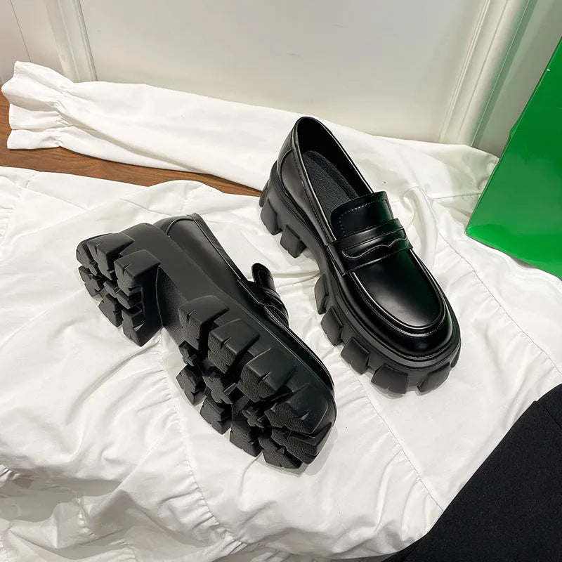 A pair of British style wide fit loafers in patent leather and matte finish options.