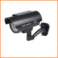Black gun-style fake surveillance camera with solar simulation flashing light for security deterrent