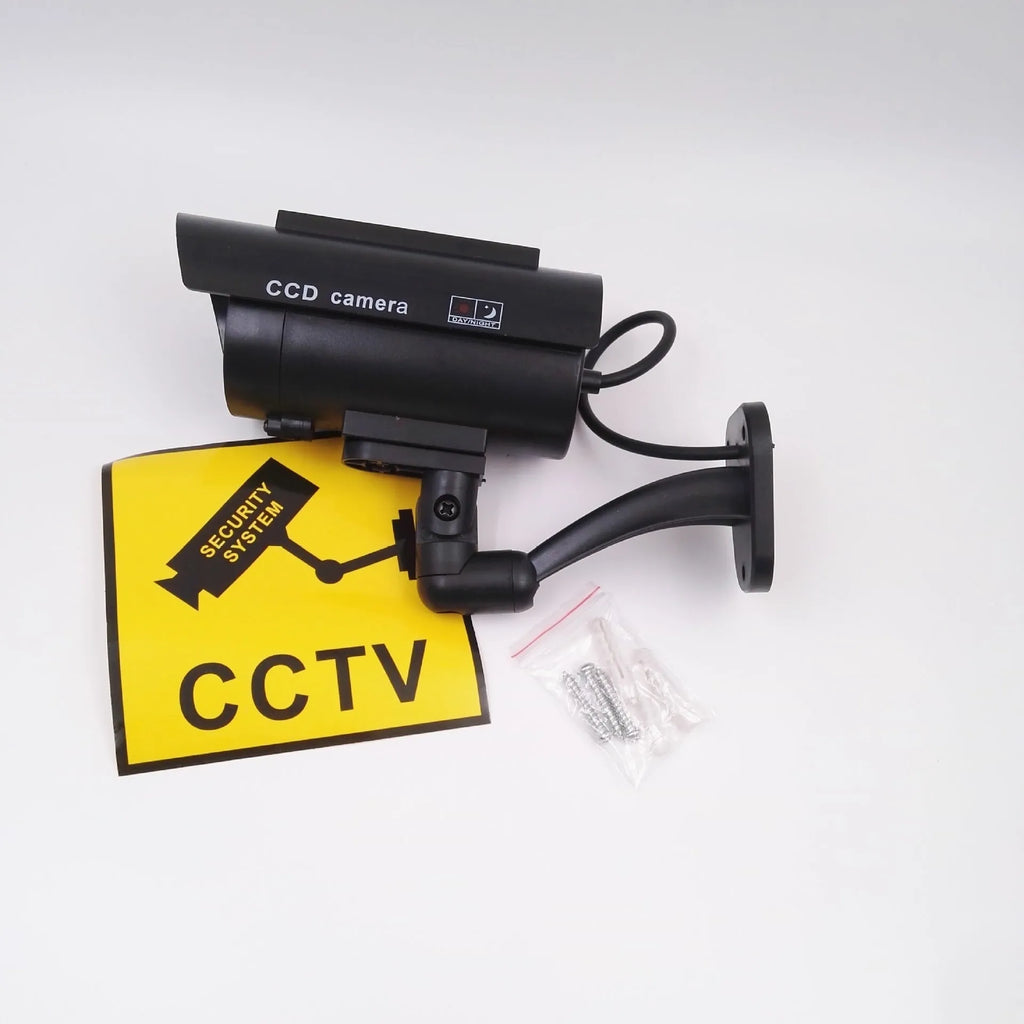 Black gun-style fake surveillance camera with solar simulation flashing light for security deterrent