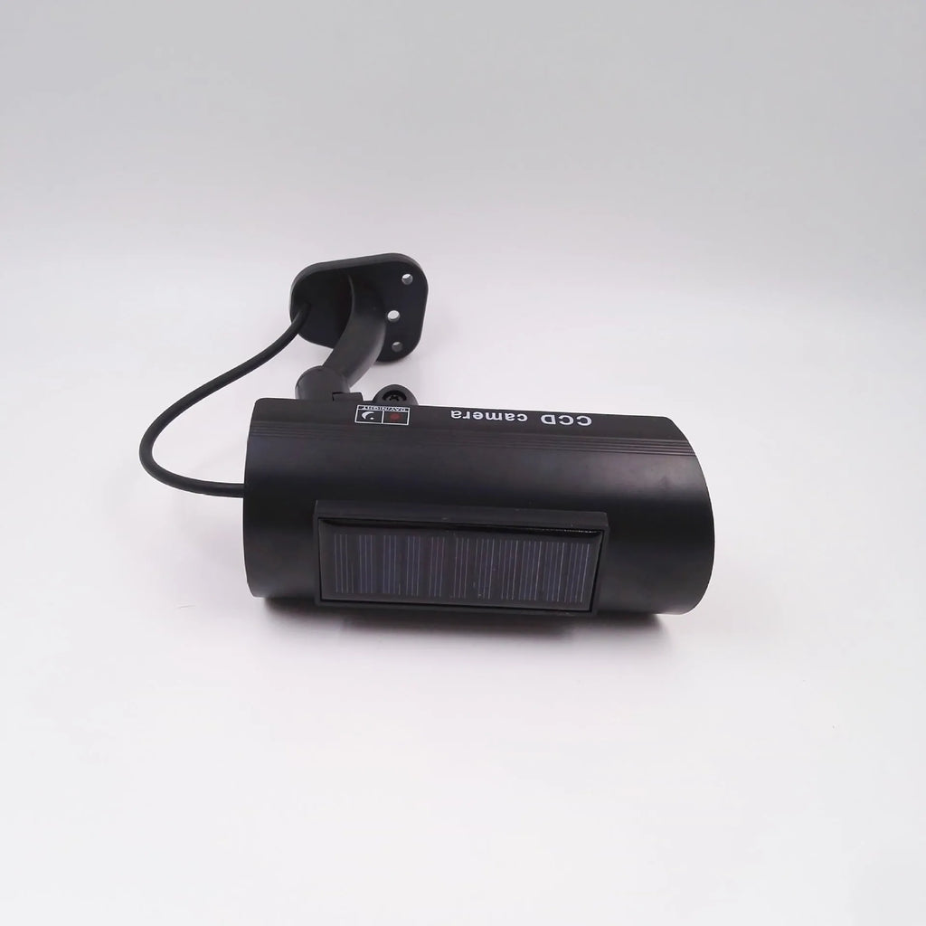 Black gun-style fake surveillance camera with solar simulation flashing light for security deterrent