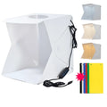40cm folding photography light box with LED ring light and multiple coloured background cloths setup for product shooting.