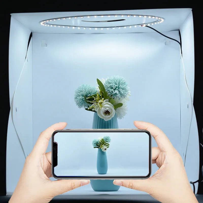 40cm folding photography light box with LED ring light and multiple coloured background cloths setup for product shooting.