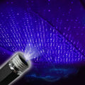 Car roof star light with aluminium housing and USB hose connection showing purple starry sky illumination