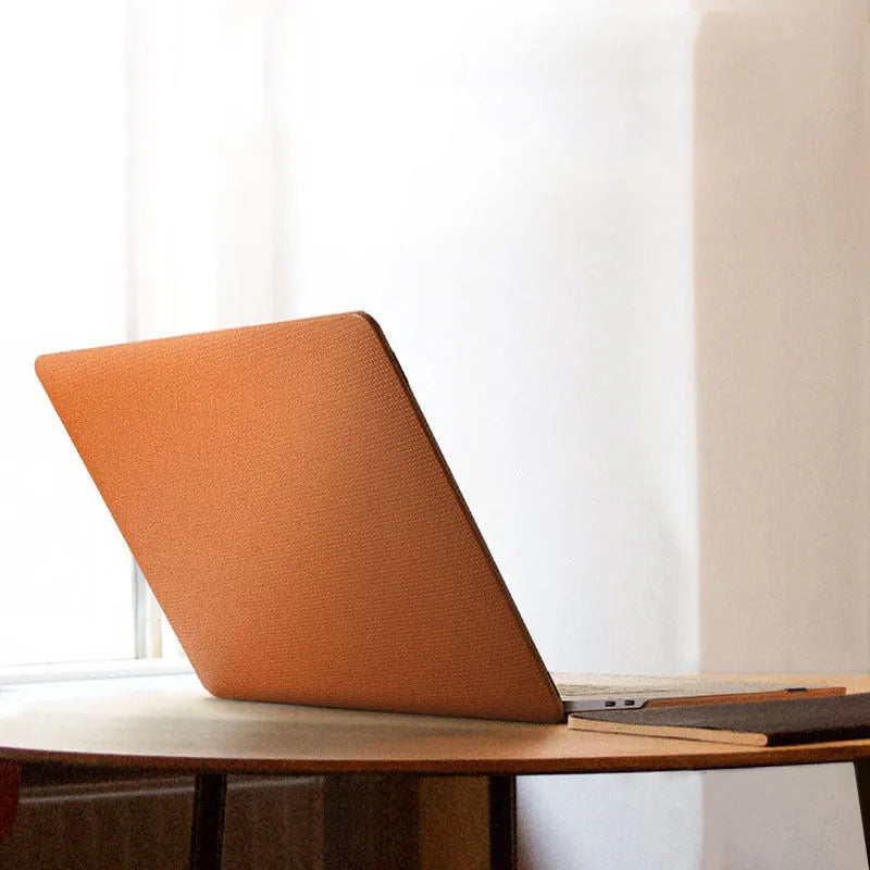 Ultra-thin leather sleeve for Apple MacBook with cross pattern, fits Pro and Air models, black colour option.