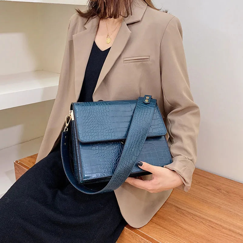 Stone pattern small square shoulder bag in PU with 25 cm width, double strap, and inner phone pocket.