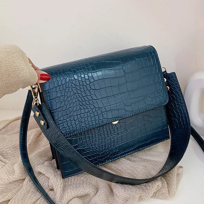 Stone pattern small square shoulder bag in PU with 25 cm width, double strap, and inner phone pocket.