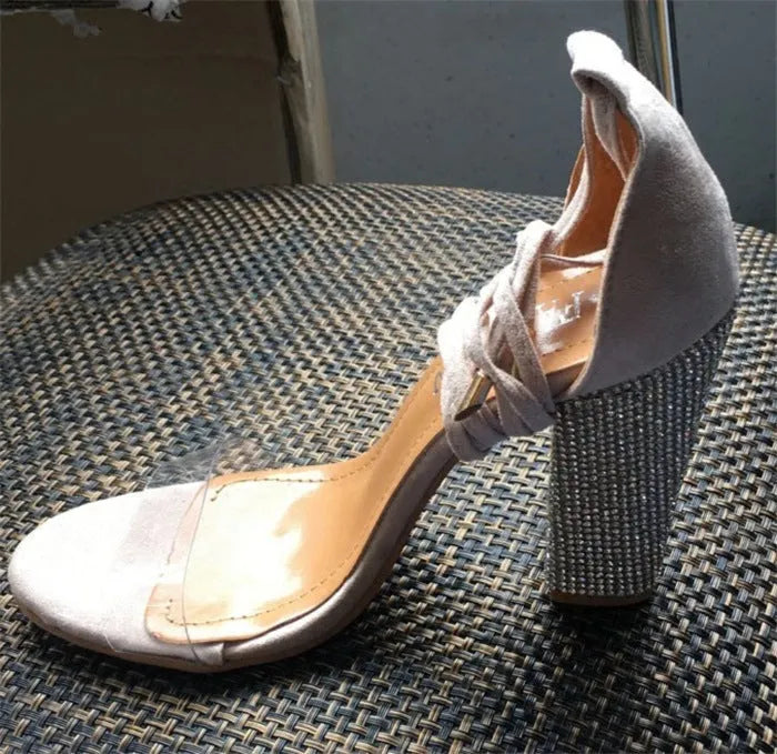 Black and gold plastic pointed toe high heels for women.