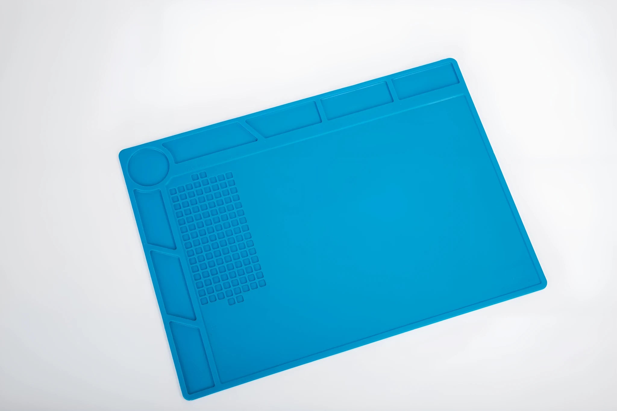 Blue silicone watch repair table mat for non-slip watchmaking and jewellery work