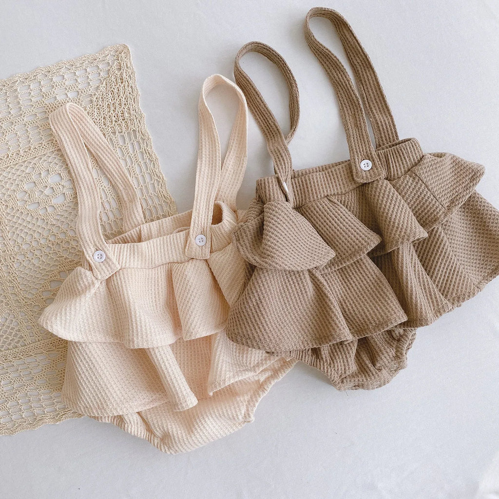 Apricot coloured baby romper with pleated lotus leaf design and sling climbing suit style for 0-2 year olds.