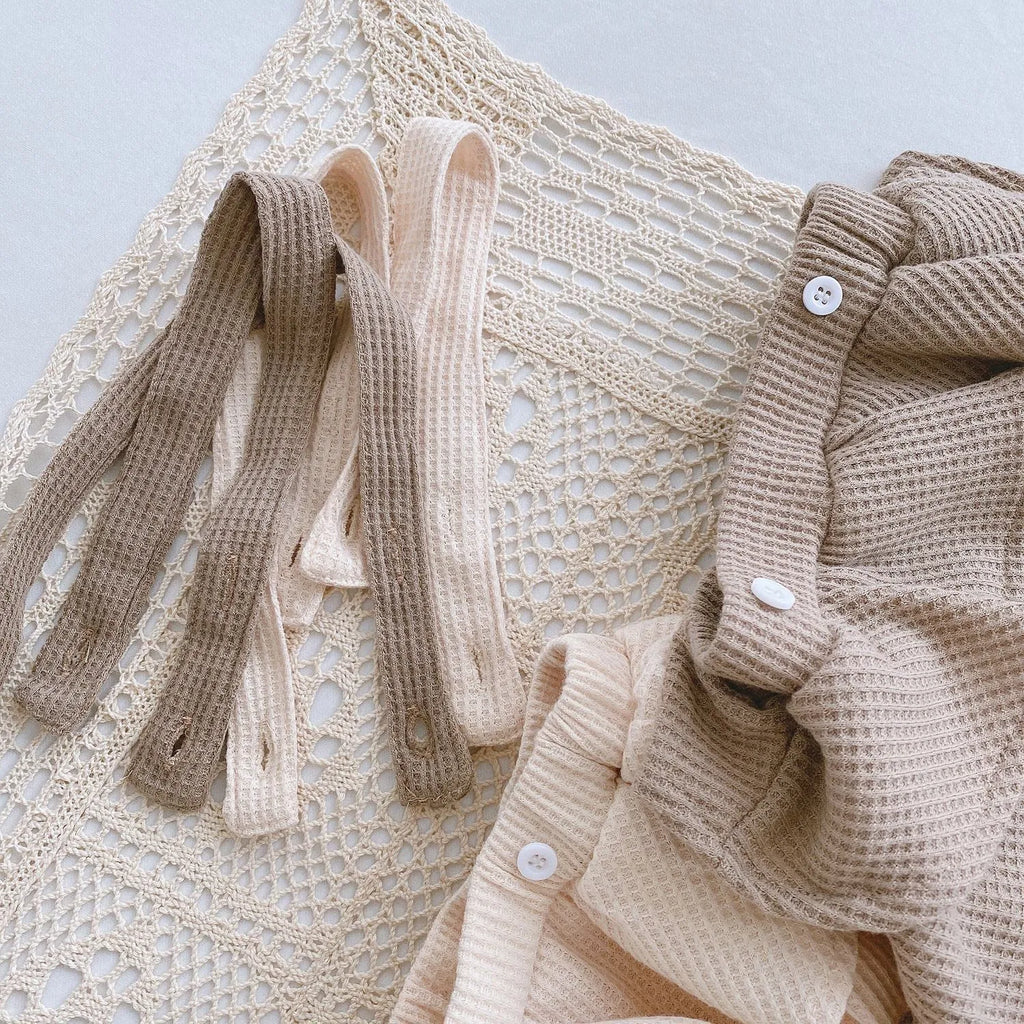 Apricot coloured baby romper with pleated lotus leaf design and sling climbing suit style for 0-2 year olds.