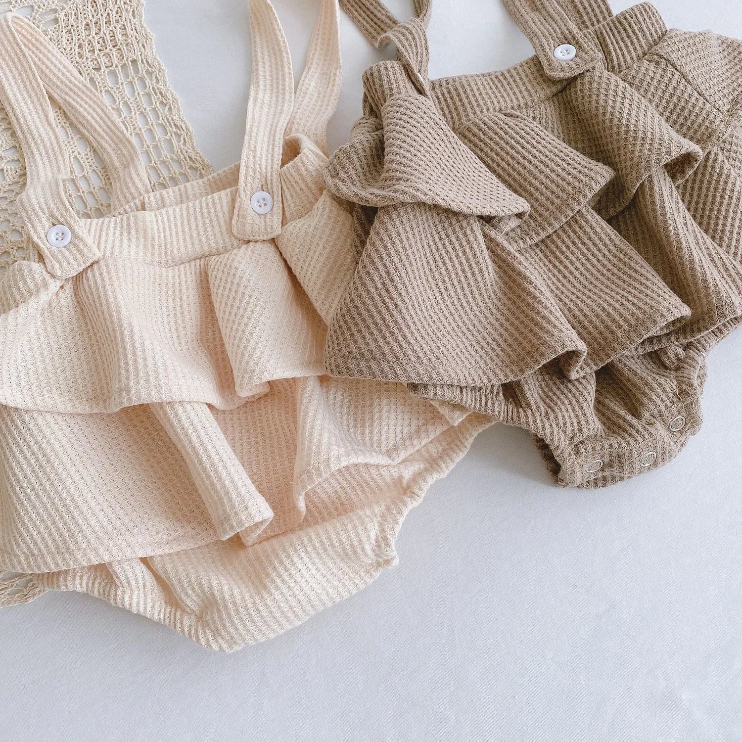 Apricot coloured baby romper with pleated lotus leaf design and sling climbing suit style for 0-2 year olds.