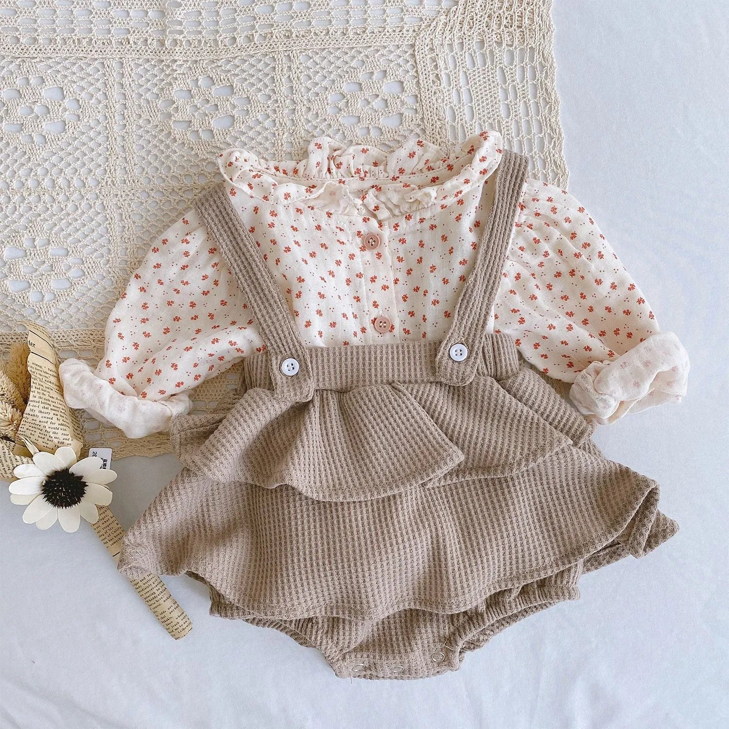 Apricot coloured baby romper with pleated lotus leaf design and sling climbing suit style for 0-2 year olds.