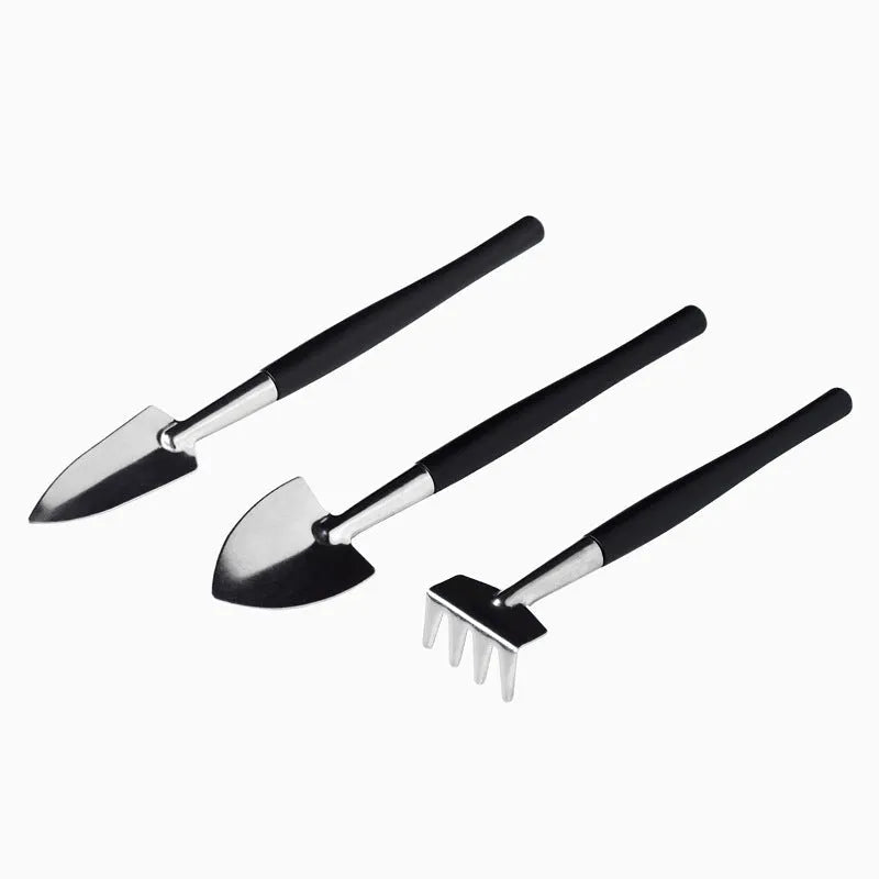 Black plastic and metal succulent gardening tool set with 15 pieces including watering bottle on 75cm square cushion