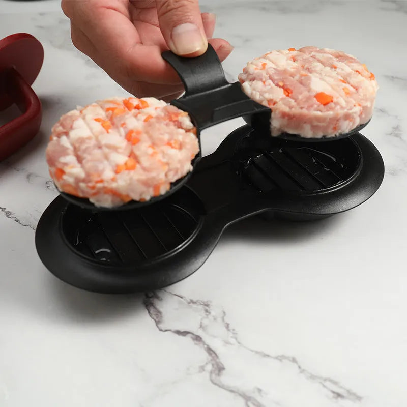 Black and red burger press gadget with non-stick moulds for making patties up to 3/4 pounds.